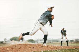 Baseball, pitch and team sports of a man pitcher busy with teamwork, fitness and fast ball throw. T