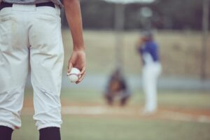 Closeup of a baseball pitcher in uniform preparing to throw the ball during a competitive game. Sof